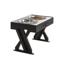 Lataa kuva Galleria-katseluun, Stylish black pet feeding station with two stainless steel bowls, featuring paw print design and a sturdy X-shaped support that can be adjusted according to the pet&#39;s growth
